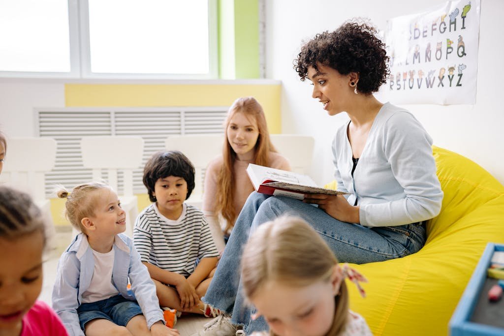 Kindergarten Teacher Reading A Book To The Class